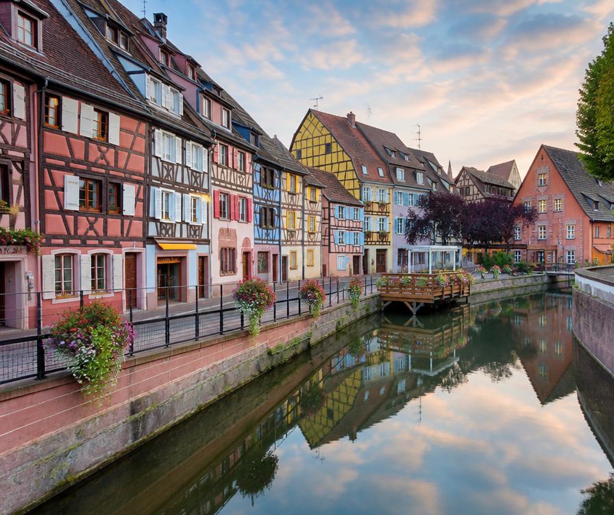 Timber-framed houses reflected in a canal in the Petite Venise quarter of Colmar